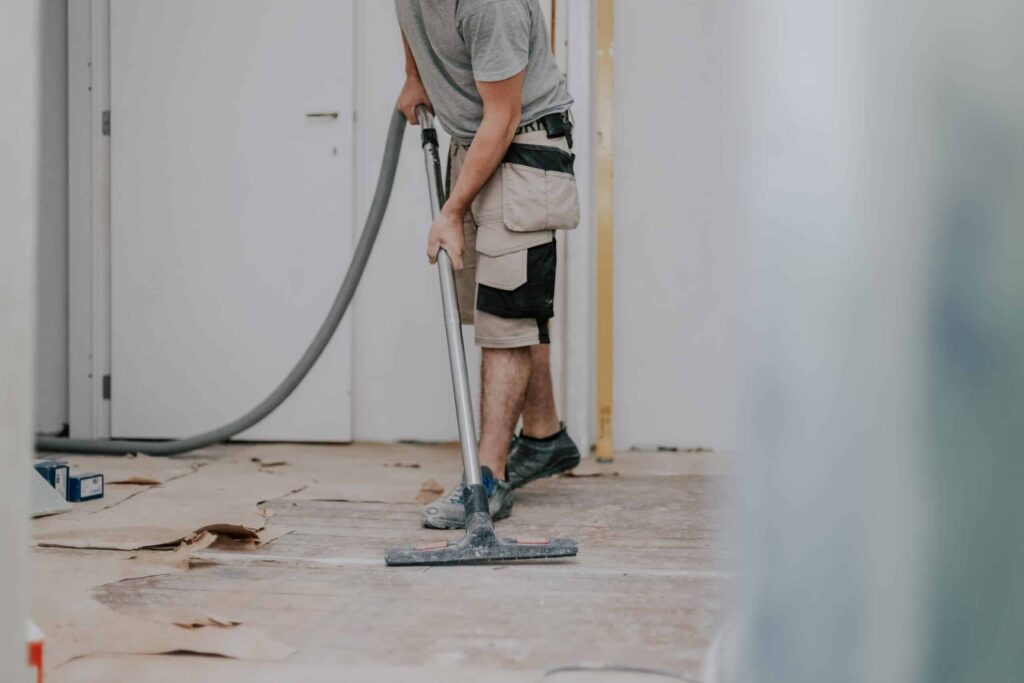 Cleaning technicians dusting new cabinetry and removing debris in a freshly completed St. Matthews condo